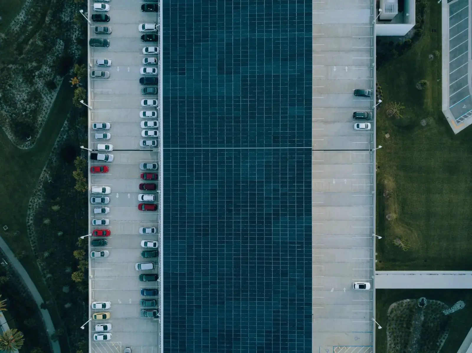 Aerial view: a canopy turns a strip of car park into a generating surface.